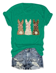 Detail of green women's T-shirt with plaid floral leopard bunny prints and denim shorts