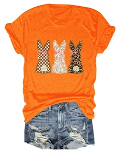 Flat lay of an orange short sleeve T-shirt with three patterned bunny silhouettes and bow details