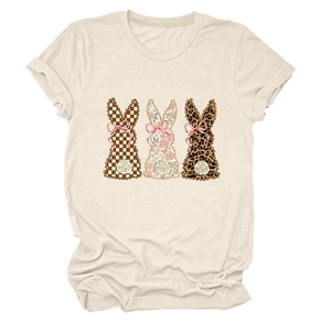 Close-up of three bunnies in plaid, floral, and leopard prints on a beige T-shirt