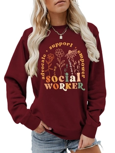 Close-up of burgundy social worker sweatshirt with floral print and empower text
