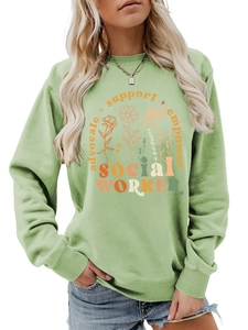 Detail of sage green sweatshirt featuring floral print and social worker empowerment text