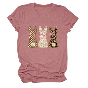 Detail of three bunny graphics with plaid, floral, and leopard textures on a pink t-shirt