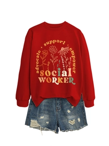 Detail view of red 'Social Worker' sweatshirt paired with distressed denim shorts