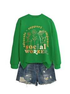 Macro shot of advocate support empower lettering and floral print on green sweatshirt