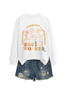 Detail of white sweatshirt with bohemian floral print and advocate support empower lettering