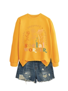 Detail of yellow sweatshirt with floral print and empower text and denim shorts