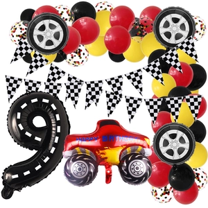 Racing car themed birthday set with monster truck, tire balloons, and checkered pennants