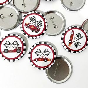 Racing party tinplate badges showing checkered flags and flame car designs on white backdrop