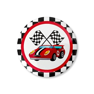 Close-up of a racing theme tinplate badge with red car and checkered flags design