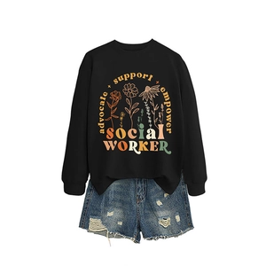 Women's black crewneck sweatshirt with empowerment print and ripped denim shorts outfit