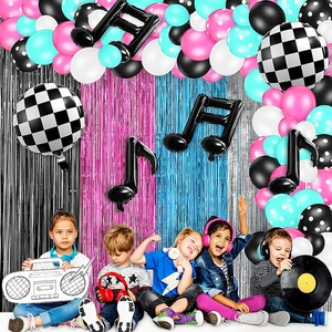 Disco music themed party set with blue and pink balloons, musical notes and tinsel curtains