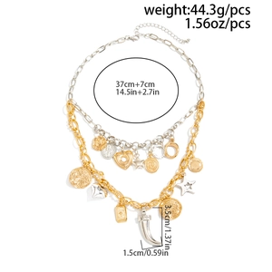 Detail view of layered gold and silver necklace with heart, star, and horn charms