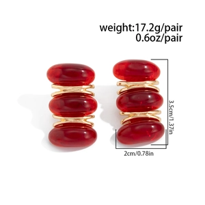 Detail view of retro red resin earrings with gold links showing 3.5cm by 2cm dimensions