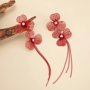 Detailed view of red metal floral tassel earrings with sparkling rhinestones decoration