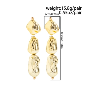 Detailed view of long gold irregular geometric earrings with size and weight metrics