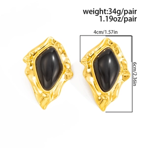 Detailed view of vintage gold earrings with black stone inlay showing 6x4cm size specs