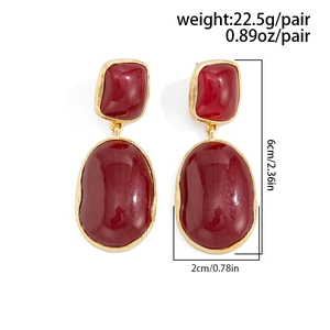 Detailed view of red geometric resin drop earrings with elegant gold metal frames