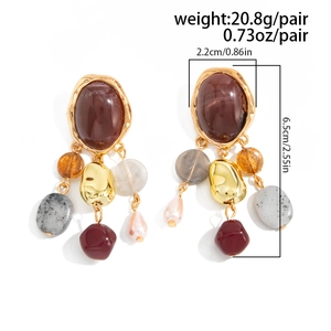 Detailed view of French vintage earrings featuring colorful beads and stone inlay