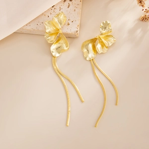 Detailed close-up of golden petal stud earrings with elegant long snake chain tassels