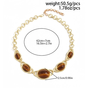 Detailed view of chunky gold chain necklace with brown tiger eye stones and size specs