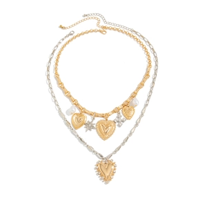 Layered gold and silver necklace set with heart star and cross charms on white background