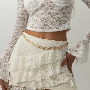 Minimalist gold hollow oval chain waist belt for women on a white lace dress