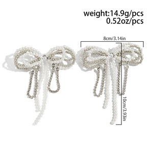 Detailed dimensions of silver bow earrings with pearls and rhinestones shown on a white background