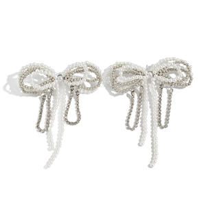 Elegant bow-shaped drop earrings with white pearls and silver fringe tassels