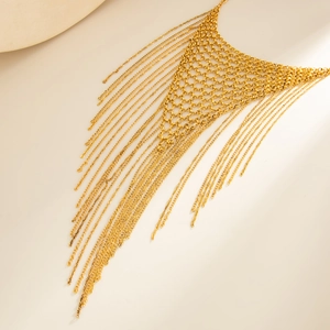 Close-up of golden mesh body chain with multi-layer fringe tassels and metallic finish
