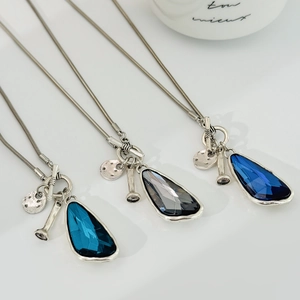 Detailed view of three faceted teardrop crystal necklaces with elegant silver T-bar clasp