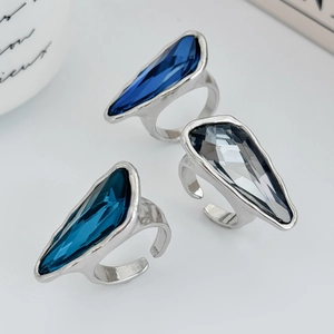 Detailed view of three faceted teardrop crystal rings with silver lava texture bands