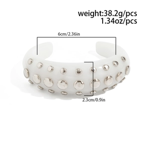 Detail view of the white resin open bangle with silver rivets, showing size dimensions