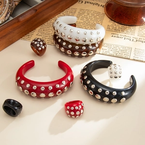 Punk resin cuff bracelets and rings with silver rivets in amber and bold solid colors