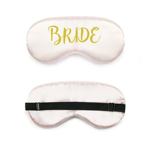 Pink satin sleep mask with golden Bride lettering and adjustable black elastic head strap
