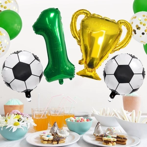 Detail of football birthday set with green number one and gold champion trophy balloons