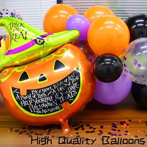 Halloween balloon set featuring large pumpkin and wizard hat balloons on wooden floor