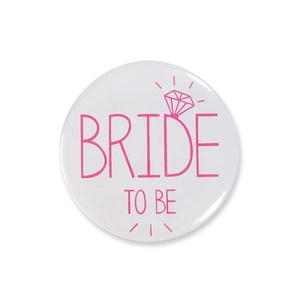 Close-up of white and pink Bride To Be badge with diamond ring graphic for bachelorette party
