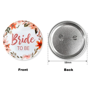 Detailed view of 58mm Bride To Be tinplate badge with floral border and safety pin back