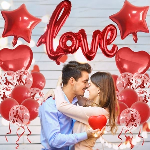 Close-up of Valentine's Day party decor set with red heart balloons and LOVE foil letters