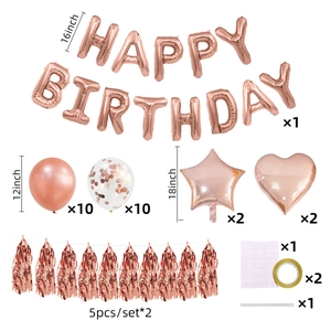 Flat lay of rose gold birthday party set with latex balloons, foil stars and tassels
