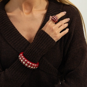 Irregular red resin jewelry set with silver studs featuring a chunky ring and bangle