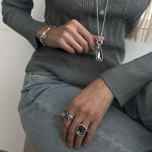 Elegant silver jewelry set with dark faceted crystals including necklace, bracelet and rings