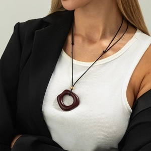 Minimalist burgundy organic ring pendant necklace with gold bead on a long black cord