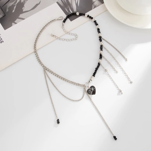 Luxurious layered tassel necklace with black heart pendant and mixed metal Cuban chains