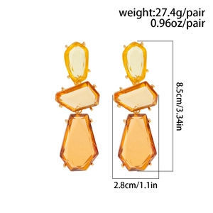 Detail view of large amber geometric drop earrings with size and weight measurements