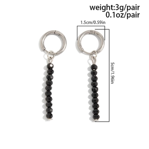 Detail view of long dangle earrings with silver metal hoops and black faceted beads