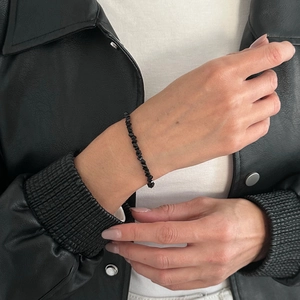 Macro detail of multifaceted black crystal beaded bracelet with irregular cut stones