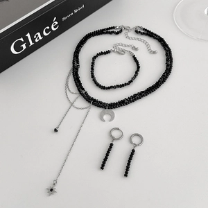 Set of black beaded necklace with moon pendant, star tassels, bracelet and earrings