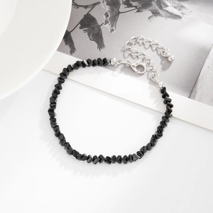 Detail of minimalist black faceted bead necklace with silver lobster clasp and extension chain