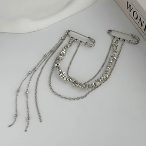Detailed view of silver multi-layer tassel chain brooch with safety pins for party suits